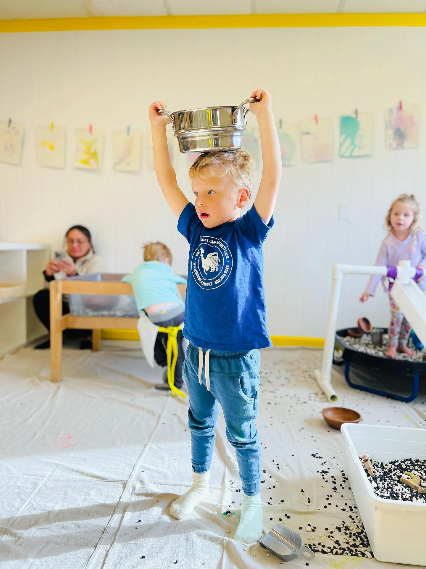 preschooler plays with pots and pans in sensory art class