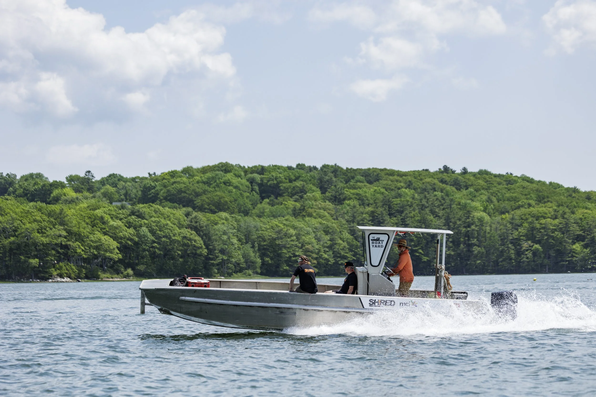 The Boat Yard's speeding across a lake in Yarmouth, Maine