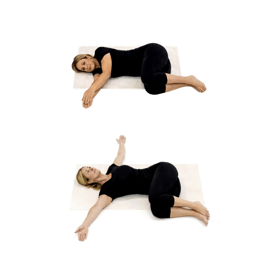 Woman doing Open Book exercise on a mat, lying on her side with knees bent, showing spine rotation and upper-back mobility.