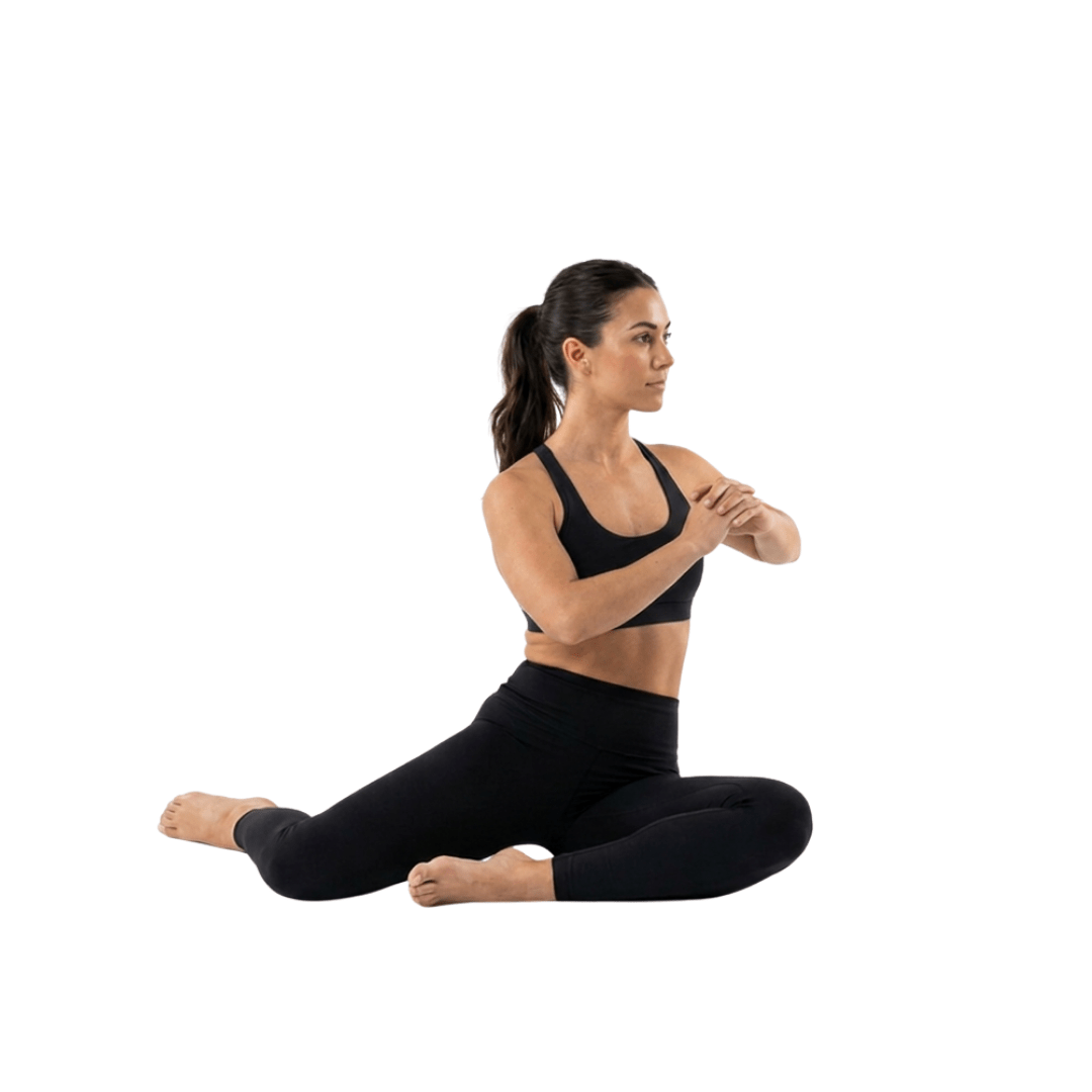 Woman doing 90/90 hip rotations on a white background, seated with legs bent, showing hip mobility and flexibility.