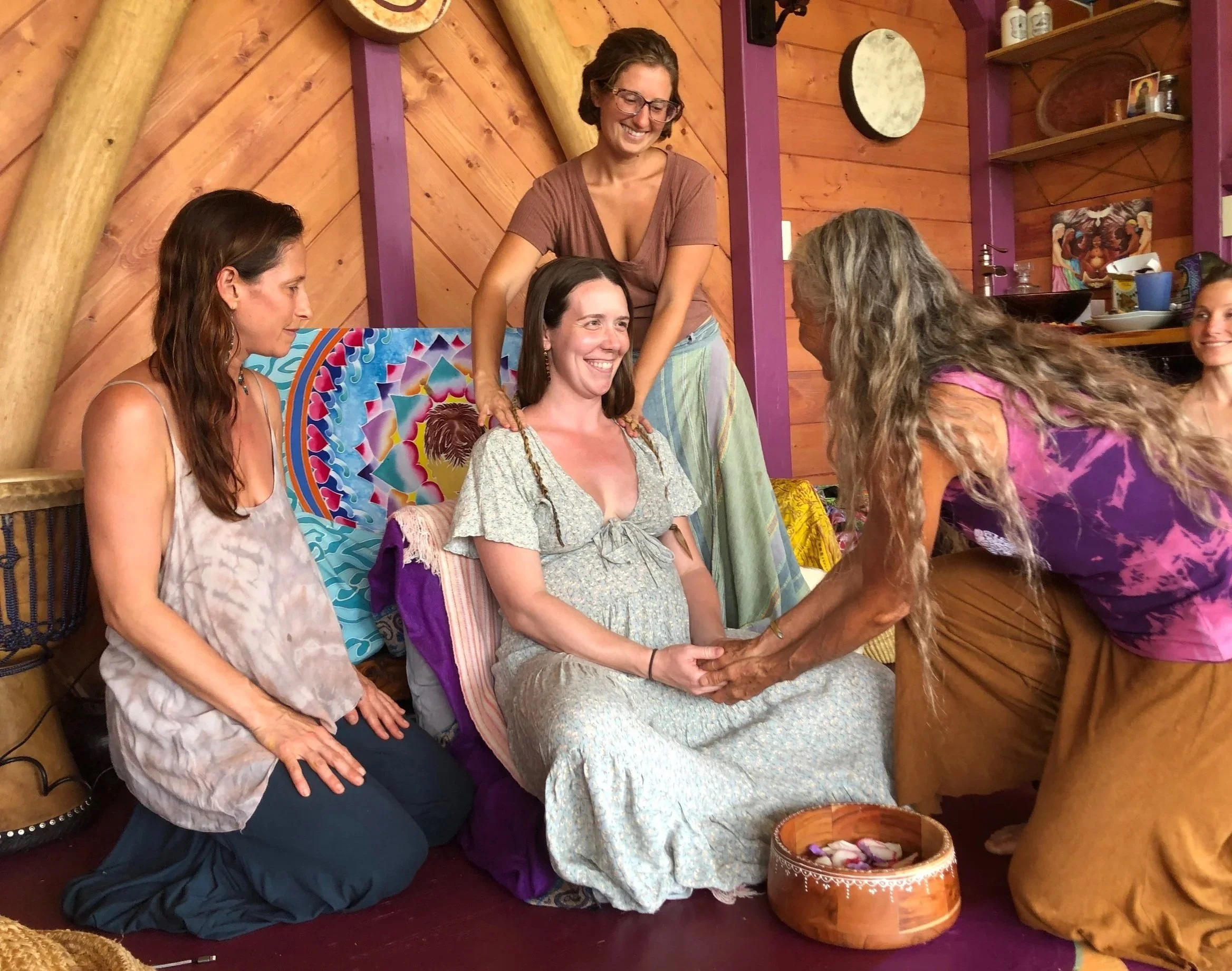 A beautiful pregnant mother being honored, respected, and supported by doulas and birth keepers who have taken the Sacred Birth Keepers Training on the Sacred Birth Path taught by Hope Medford.  SacredBirthPath.com