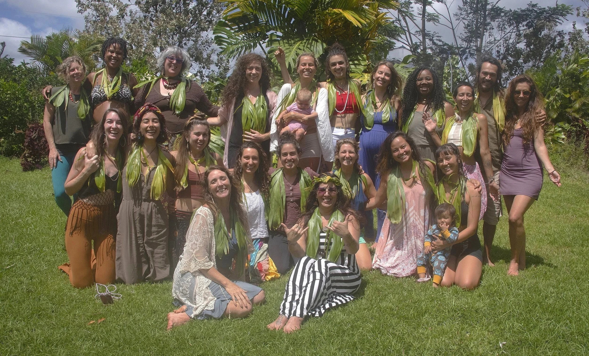 Sacred Birth Class in Hawaii of doulas, birth keepers, students, mamas, babies and a Hawaiian Kumu and the facilitator, Hope Medford, smiling together while  enjoying the sisterhood of sacred birth work. SacredBirthPath.com