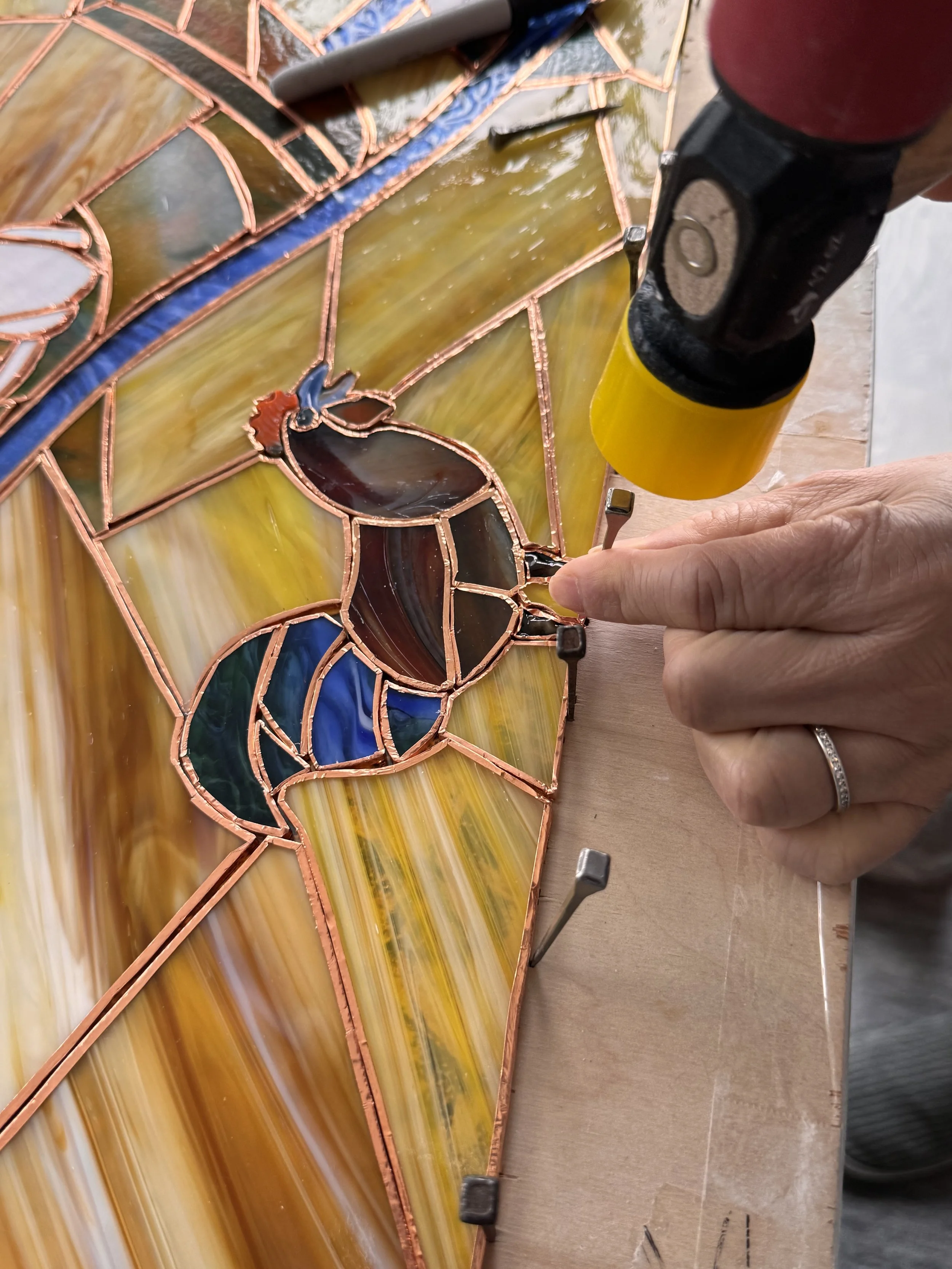 Horseshoe nails securing rooster in Mornin'
