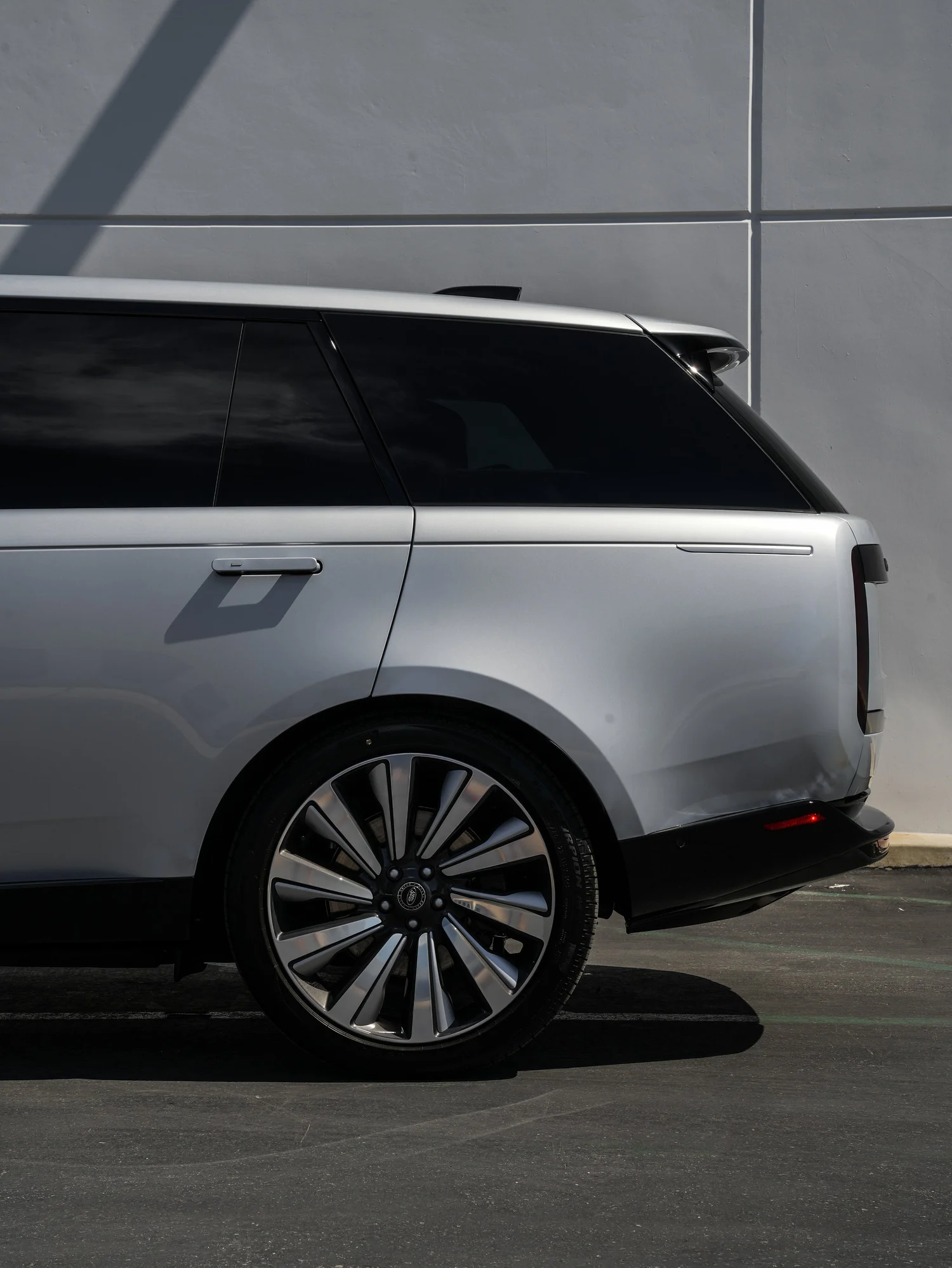 Range Rover SV driver-side rear quarter and wheel detail after full exterior PPF, window tint and ceramic coating