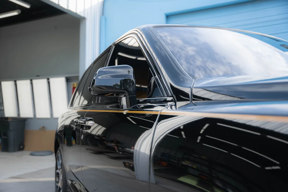 Reflections along the black front fender, side mirror and window trim.