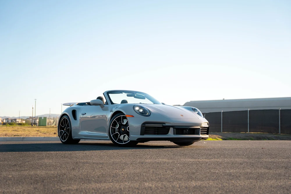 Chalk Porsche 911 Turbo S, complete low front three-quarter view with roof open