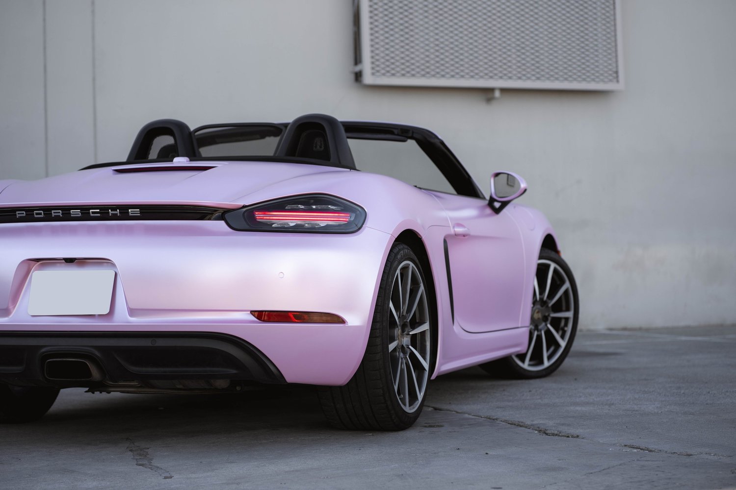 Porsche 718 Boxster Matte Purple Pink after Vinyl Wrap, rear-right three-quarter view