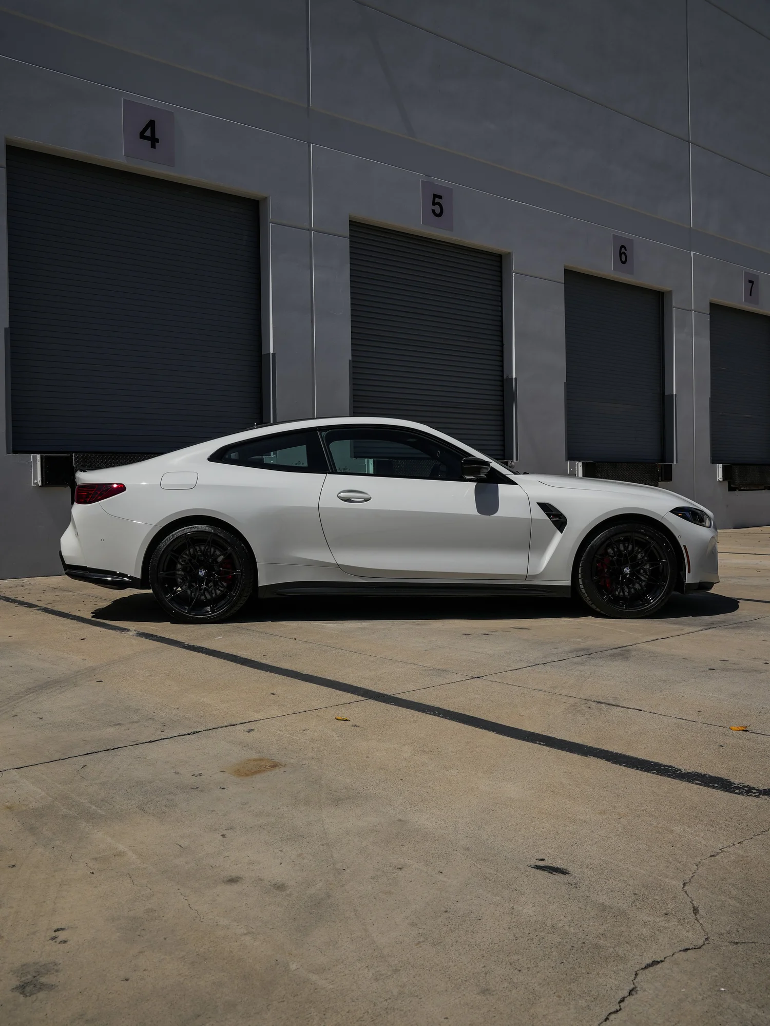 BMW G82 M4 after Paint Protection Film (PPF), rear-left three-quarter view