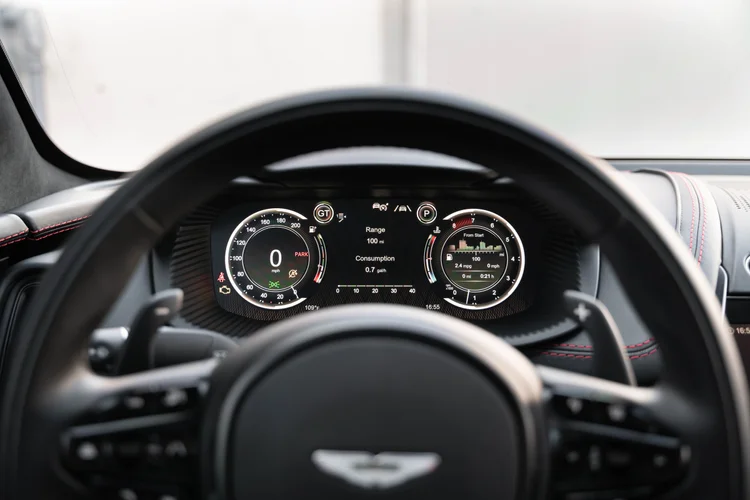 Digital instrument display behind the Aston Martin steering wheel.