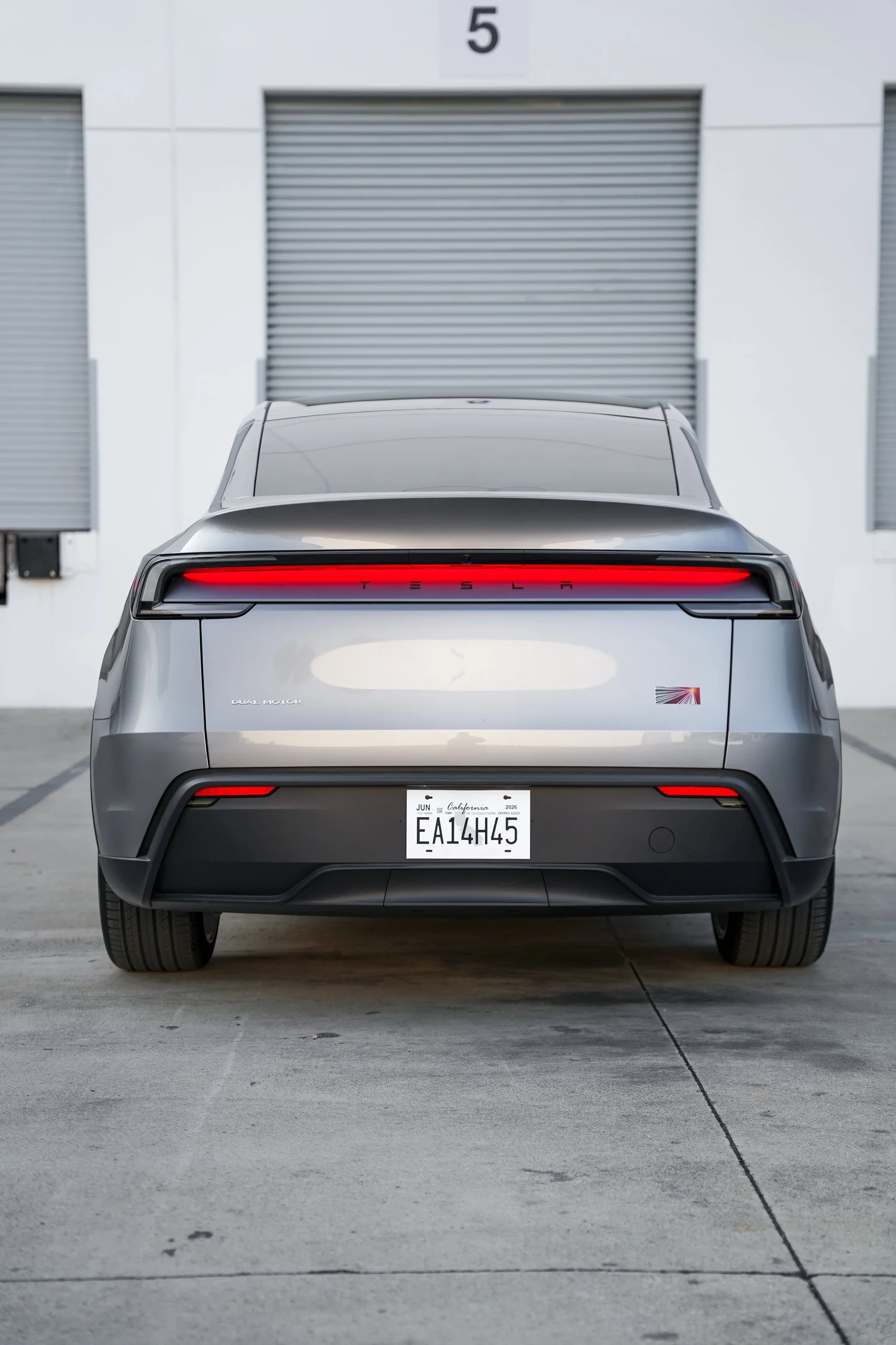 Grey Tesla Model Y after Paint Protection Film (PPF), Window Tint and Ceramic Coating, rear body and taillight view
