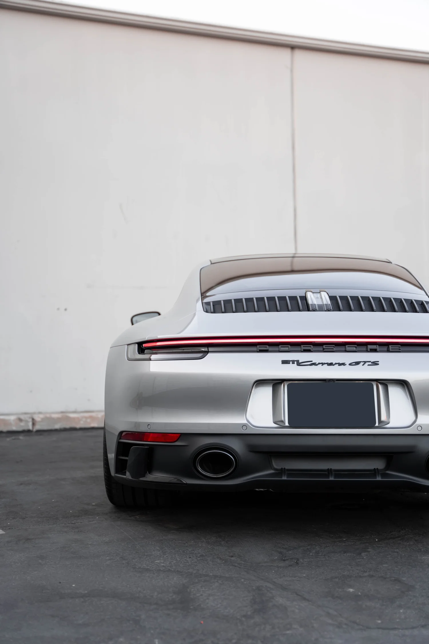 Porsche 911 Carrera GTS (992.1) after Paint Protection Film (PPF), Window Tint, Ceramic Coating and Custom Graphics, tight rear three-quarter view