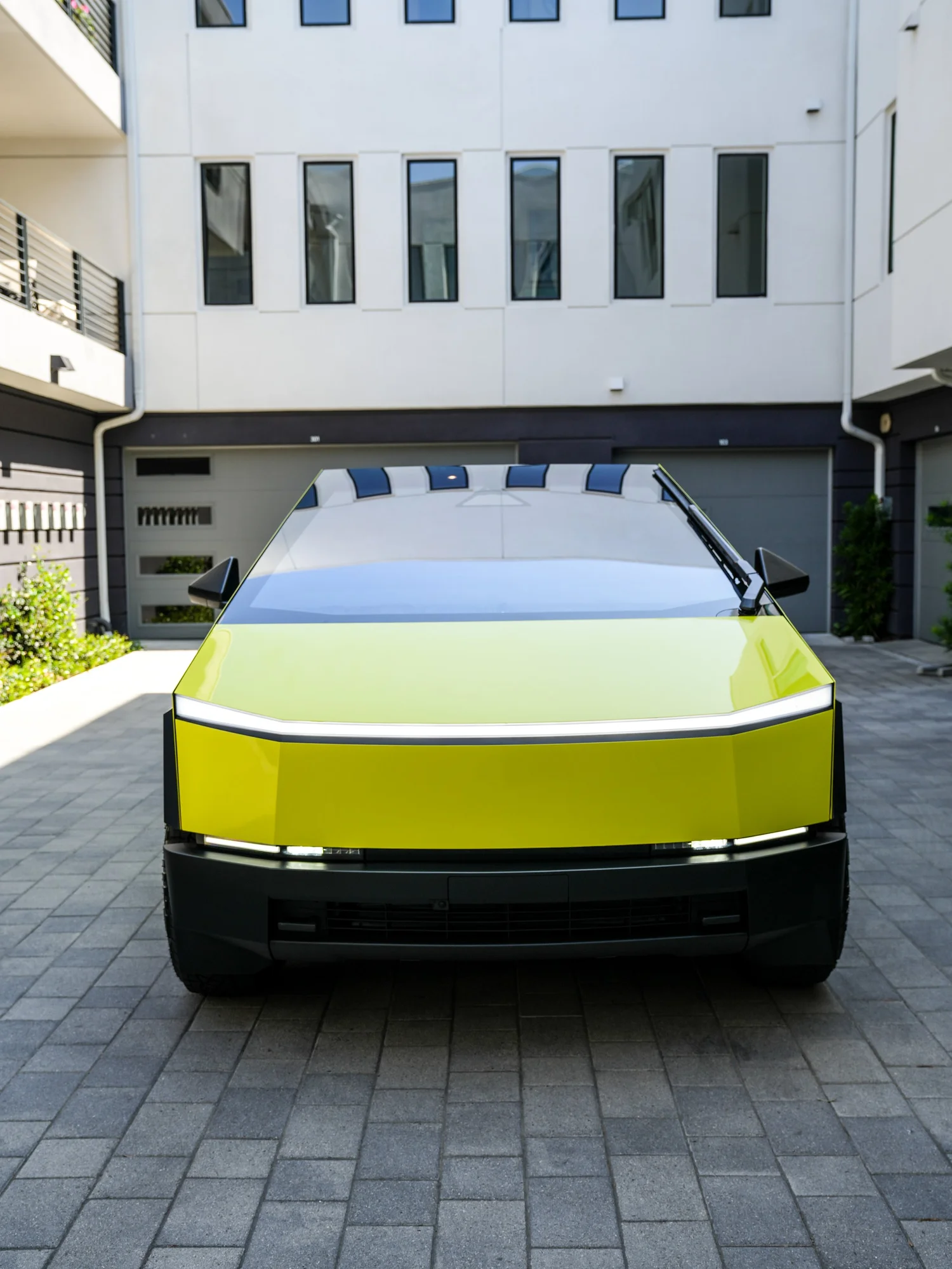 Tesla Cybertruck Inozetek Racing Yellow after Window Tint and Vinyl Wrap, low-angle rear view