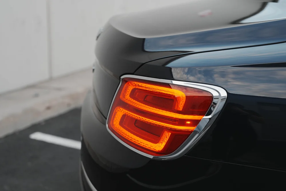 Rear lamp close-up with two glowing outlines against the dark body.