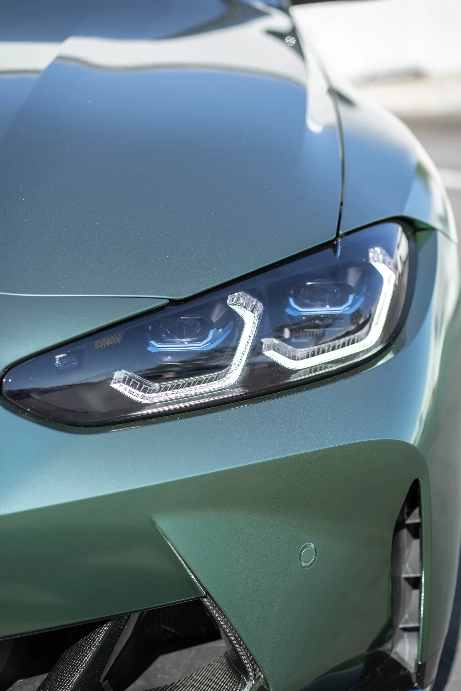BMW M4 Racing Green after Vinyl Wrap, front bumper and headlight detail