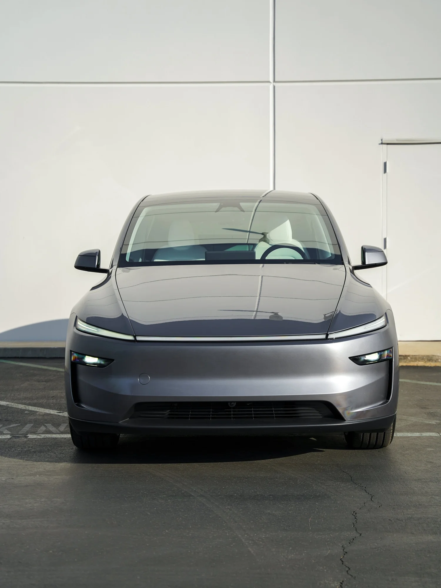 Grey Tesla Model Y after Paint Protection Film (PPF), Window Tint and Ceramic Coating, front-right three-quarter view