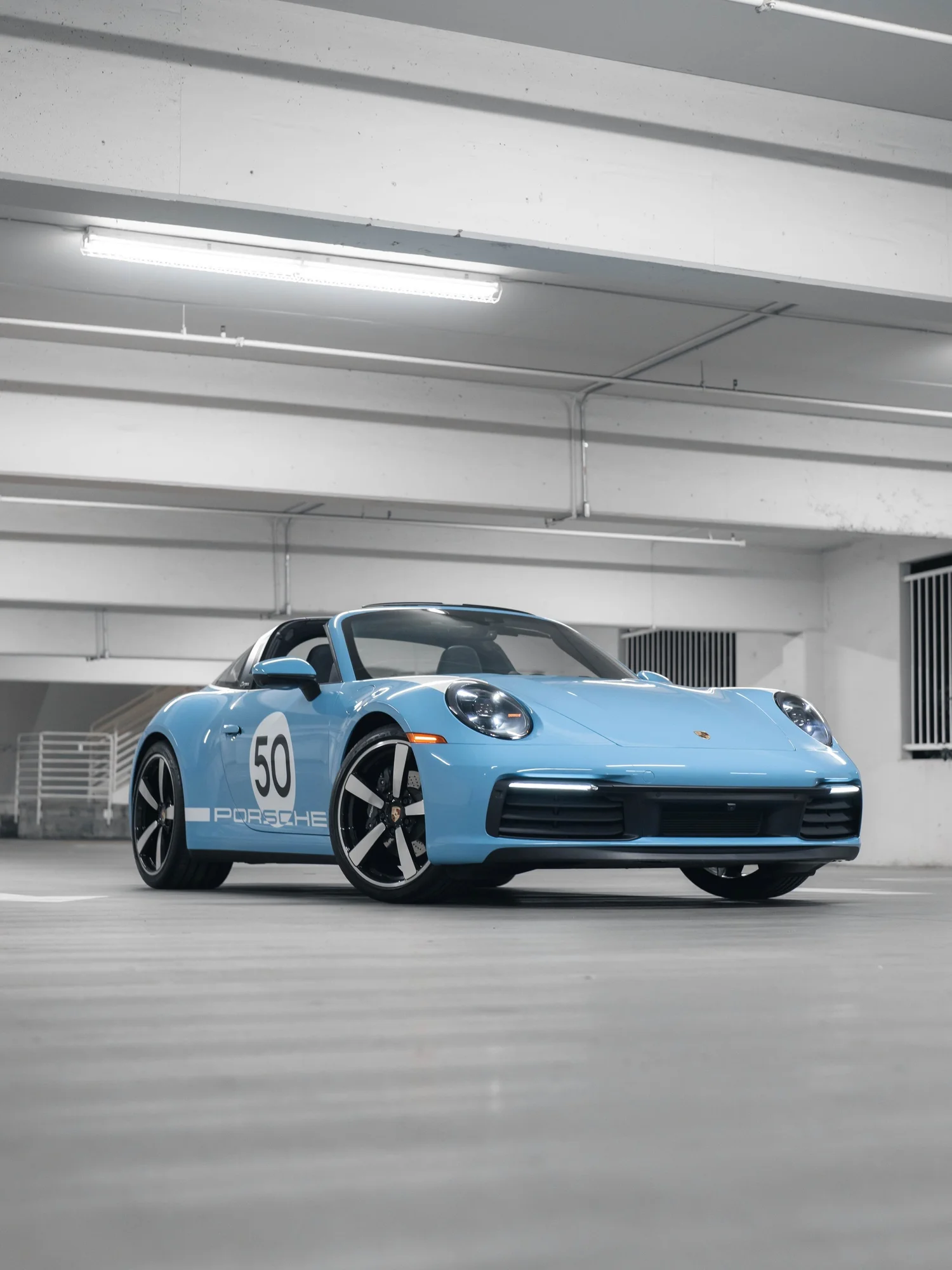Light blue Porsche convertible with number 50 in an authentic Toyz Detail Studio wrap project