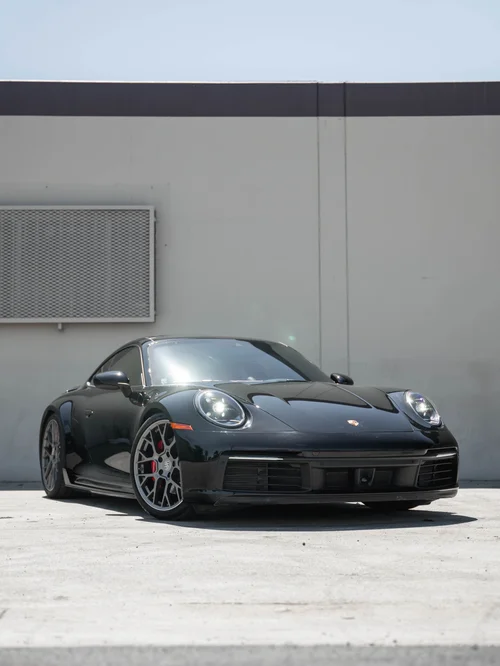Front three-quarter view of a dark Porsche 911 Carrera S 992.1 at Toyz Detail Studio.
