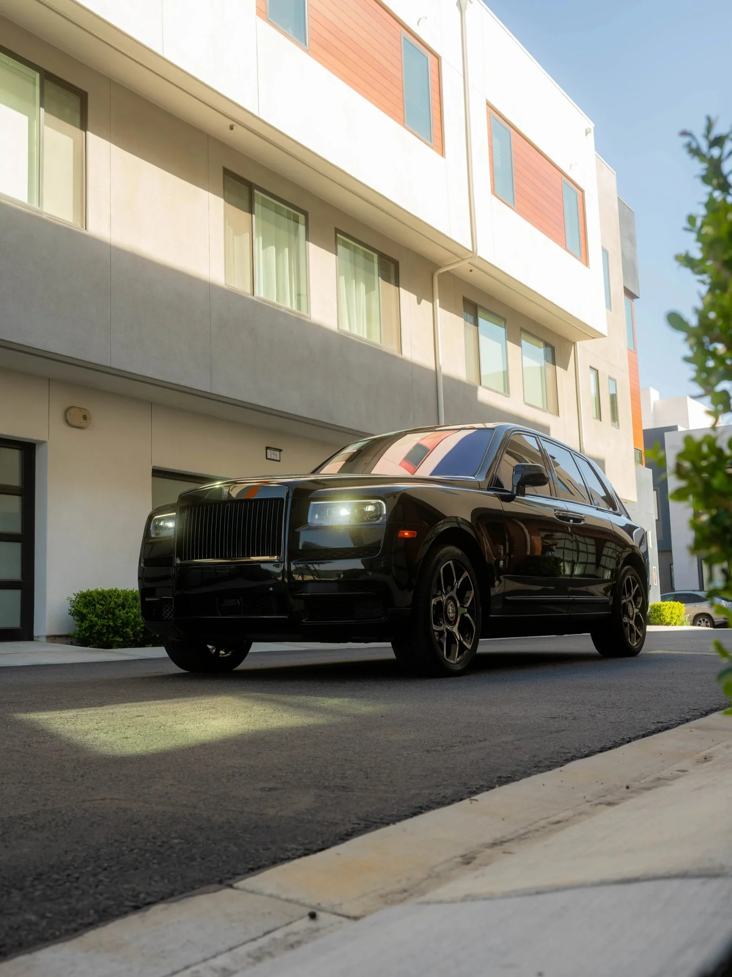 Black Rolls-Royce Cullinan Black Badge with Two-Tone Wheels after Paint Protection Film (PPF), Window Tint and Ceramic Coating, low-angle front view