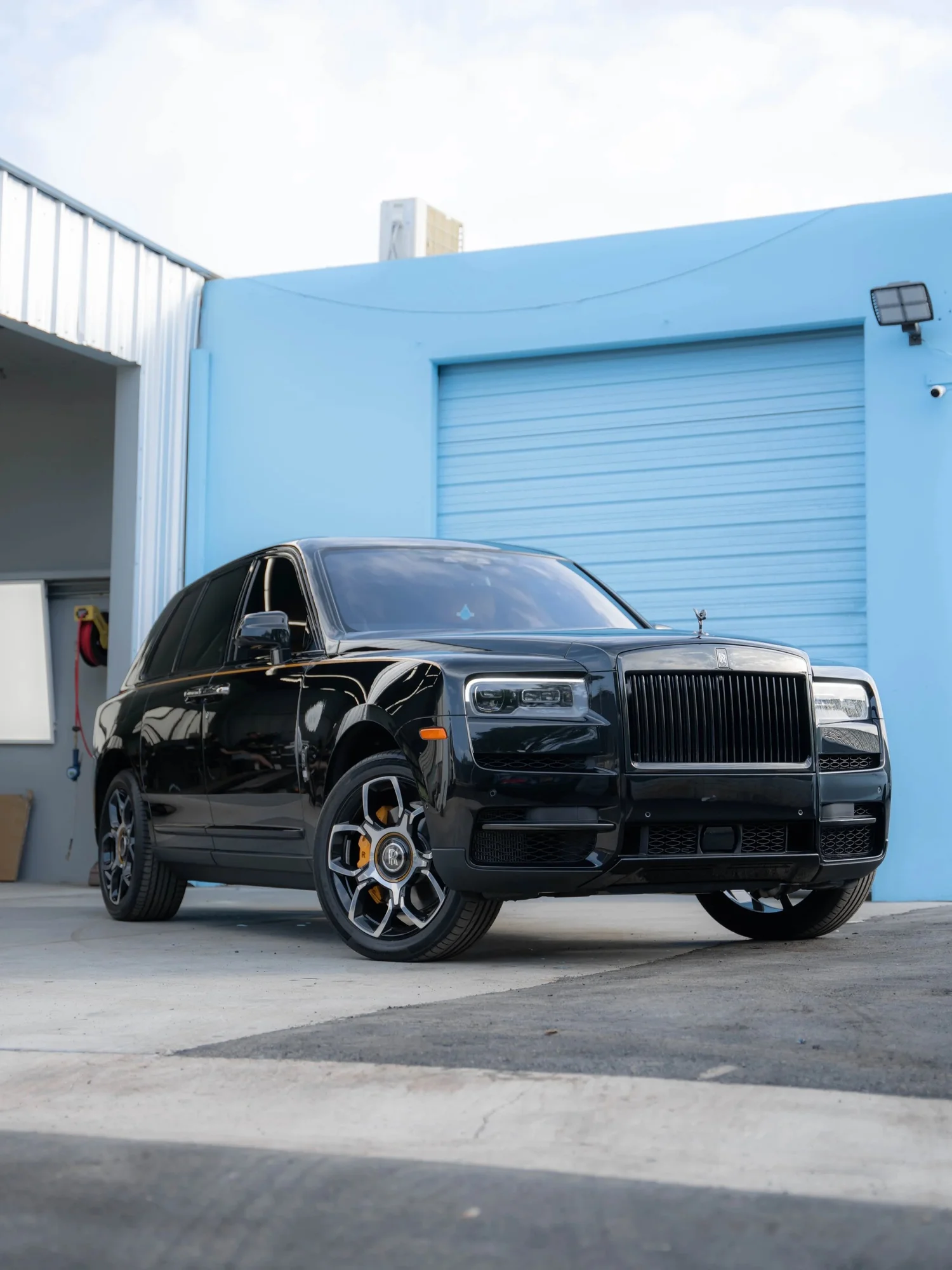 Black Rolls-Royce Cullinan Black Badge with Yellow Brake Calipers after Paint Protection Film (PPF), Window Tint and Ceramic Coating, front-right three-quarter view