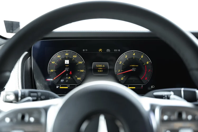 Digital instrument display with round gauge graphics and yellow numerals viewed behind the G 550 steering wheel