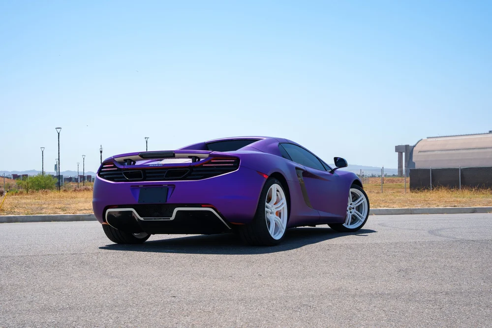 McLaren MP4-12C — complete rear three-quarter view from a low outdoor viewpoint