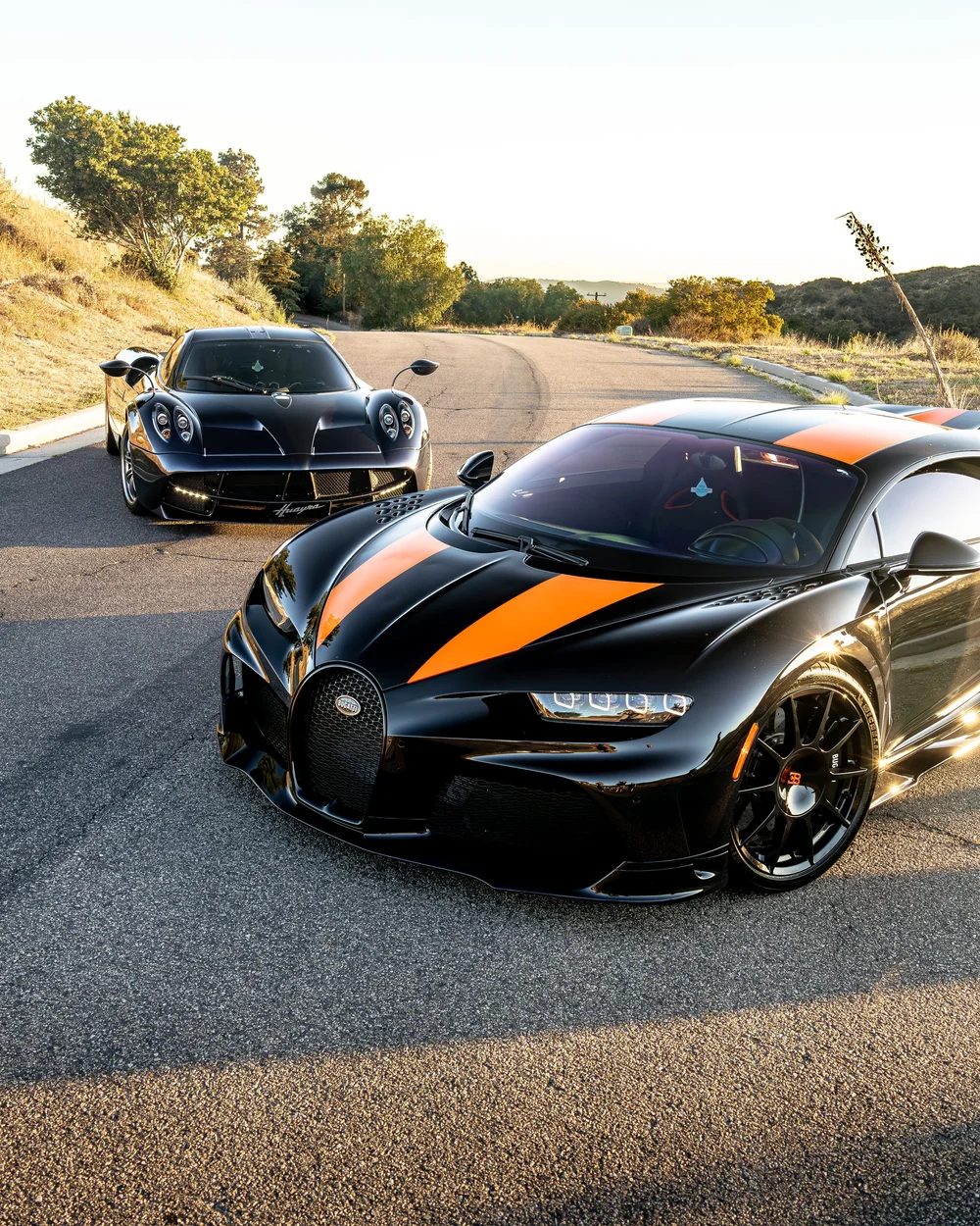 Bugatti Chiron Super Sport 300+ with Pagani Huayra behind at sunset