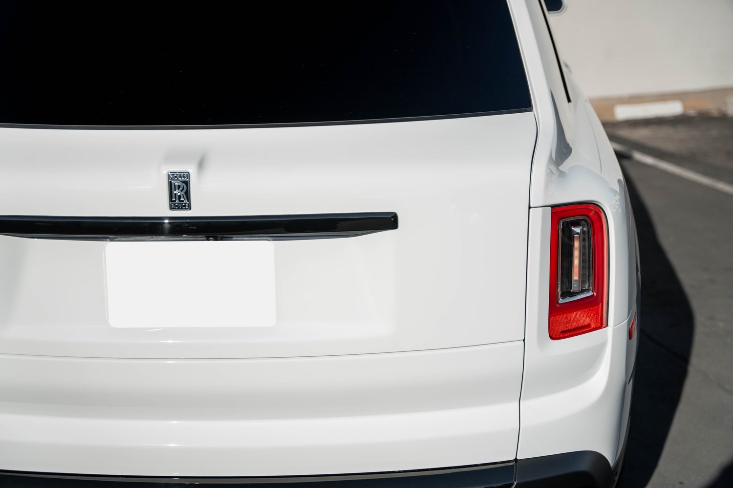 White Rolls-Royce Cullinan after Paint Protection Film (PPF), Window Tint and Ceramic Coating, rear bumper and taillight detail