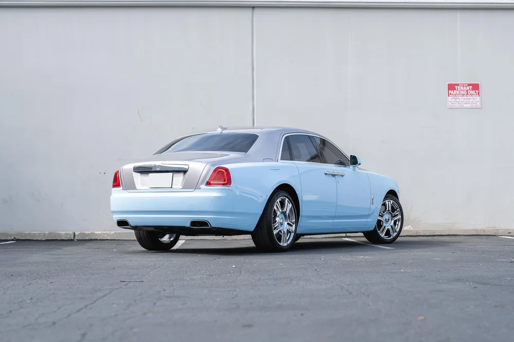 Rolls-Royce Ghost — complete rear three-quarter view from a distant landscape viewpoint