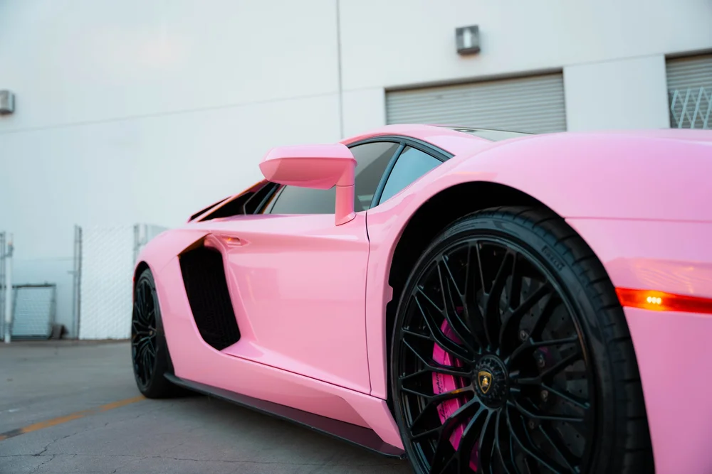 Sakura Pink Aventador side bodywork with the door closed, pink mirror, black front wheel and sculpted intake