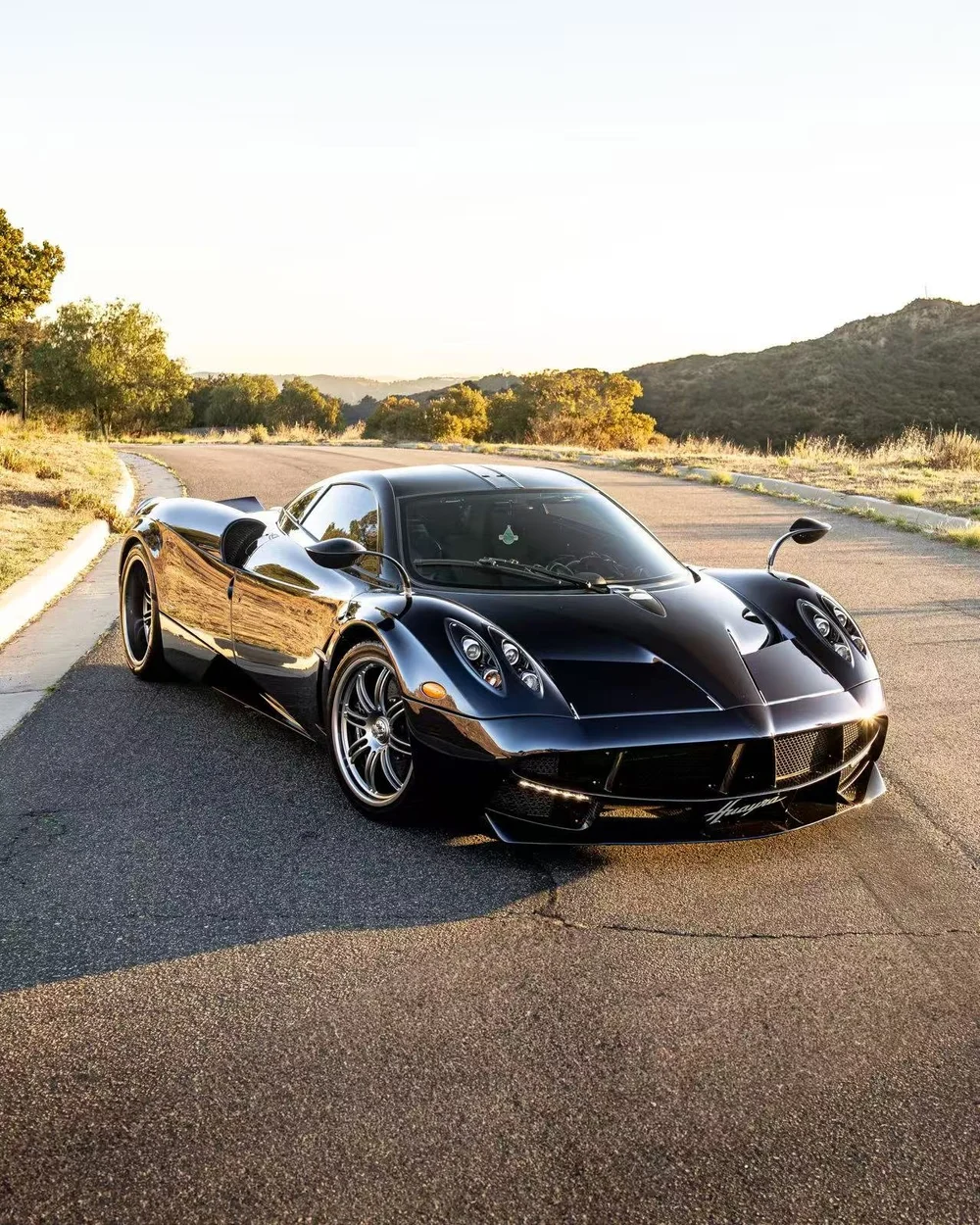 Black Koenigsegg photographed after detailing at sunset