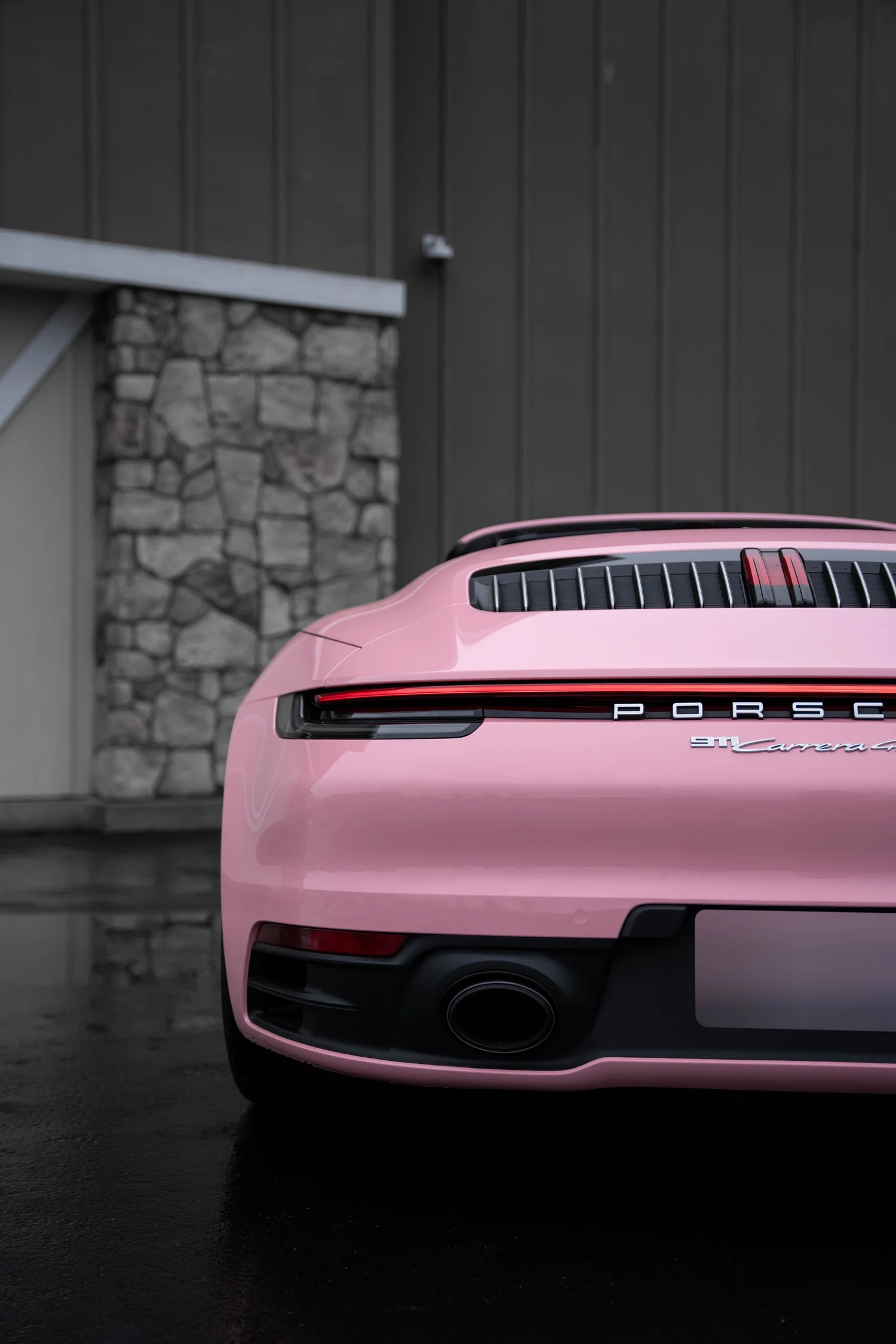 Porsche 911 Sakura Pink after Vinyl Wrap, low-angle rear view