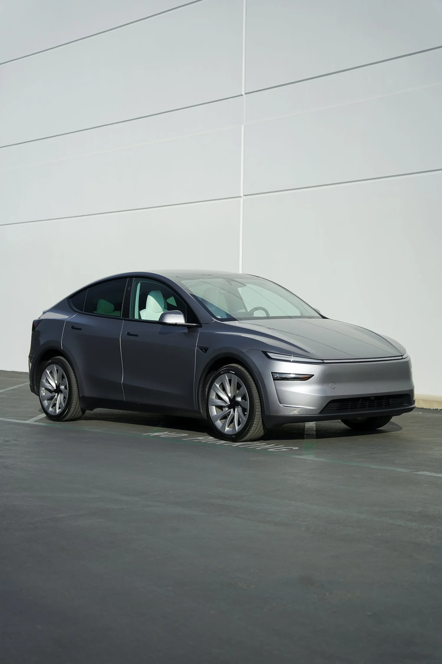 Grey Tesla Model Y after Paint Protection Film (PPF), Window Tint and Ceramic Coating, front-left three-quarter view