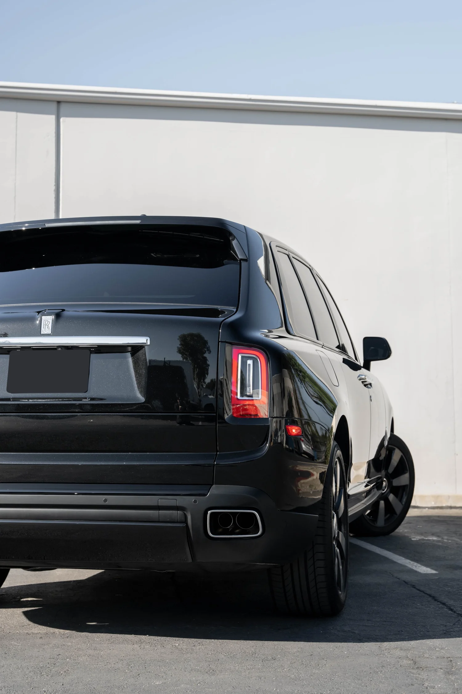 Dark Metallic Grey Rolls-Royce Cullinan after Paint Protection Film (PPF), Window Tint and Ceramic Coating, tight rear three-quarter view