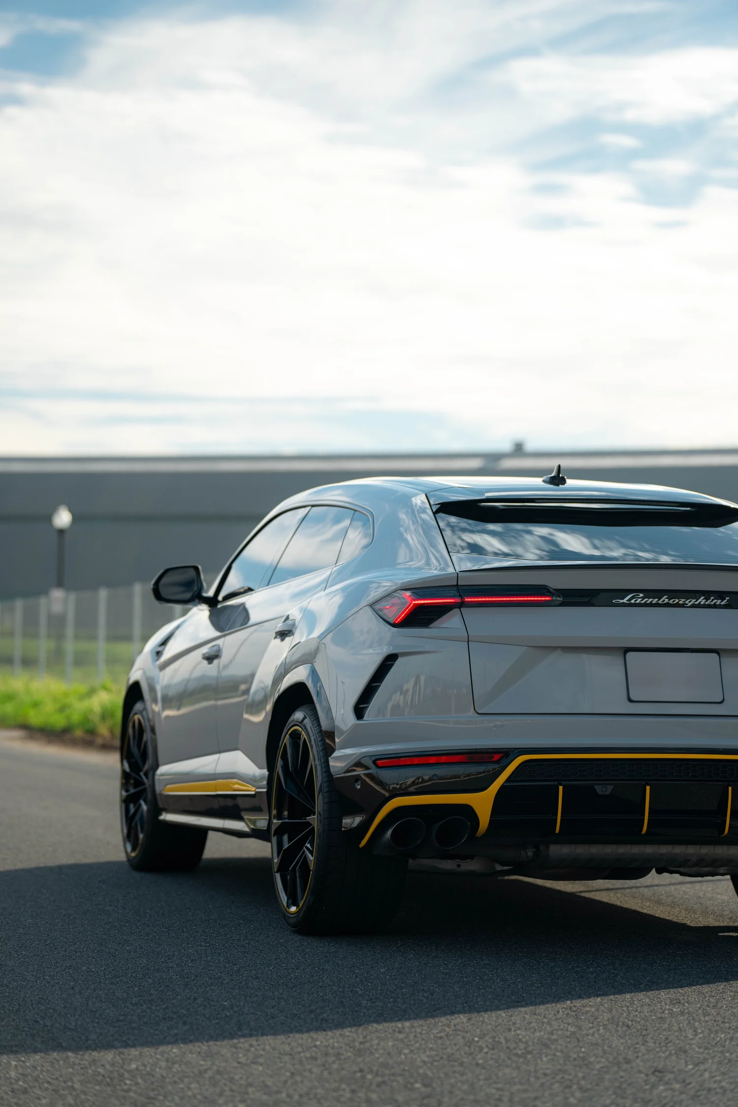 Lamborghini Urus Chalk after Vinyl Wrap, low-angle rear view