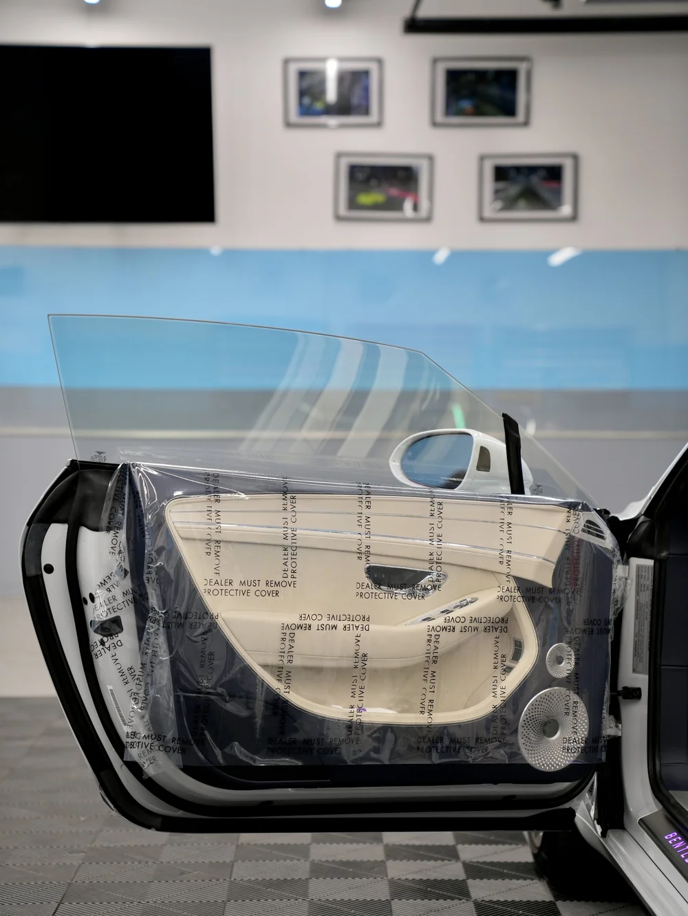 Vehicle door glass prepared for window tint installation at Toyz Detail Studio.