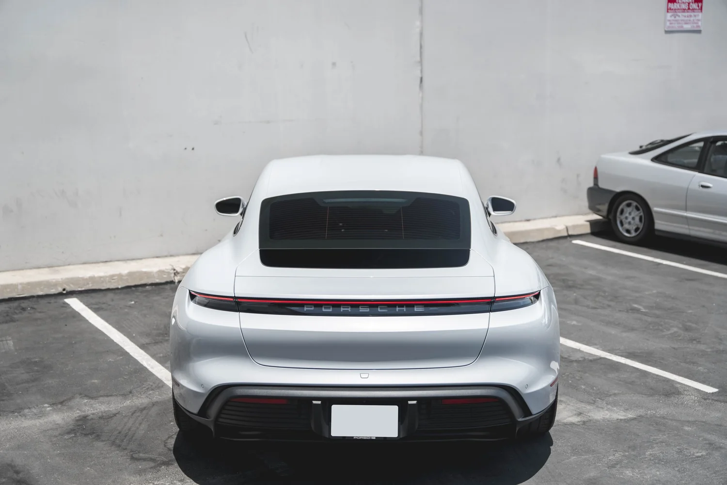 Porsche Taycan after Paint Protection Film (PPF), Window Tint and Ceramic Coating, high-angle complete-vehicle view