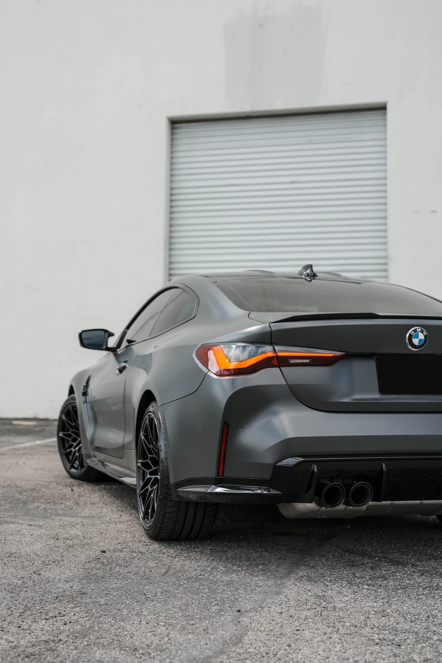 Black BMW M4 after Matte PPF, Window Tint and Ceramic Coating, low-angle rear view