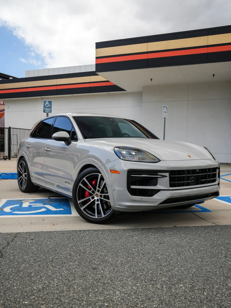 Light grey Porsche Cayenne GTS in a complete front three-quarter view.