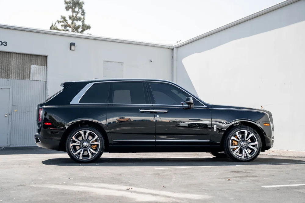 Black Rolls-Royce Cullinan with Chrome Exterior Trim — full side profile with bright window surrounds, handles and lower-body trim