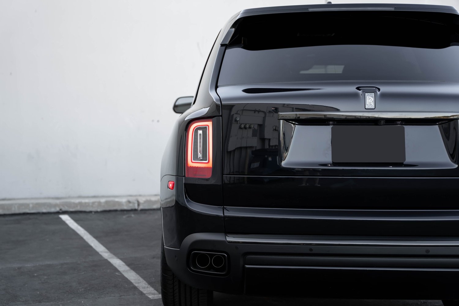 Black Rolls-Royce Cullinan Black Badge after Paint Protection Film (PPF), Window Tint and Ceramic Coating, rear body and taillight view