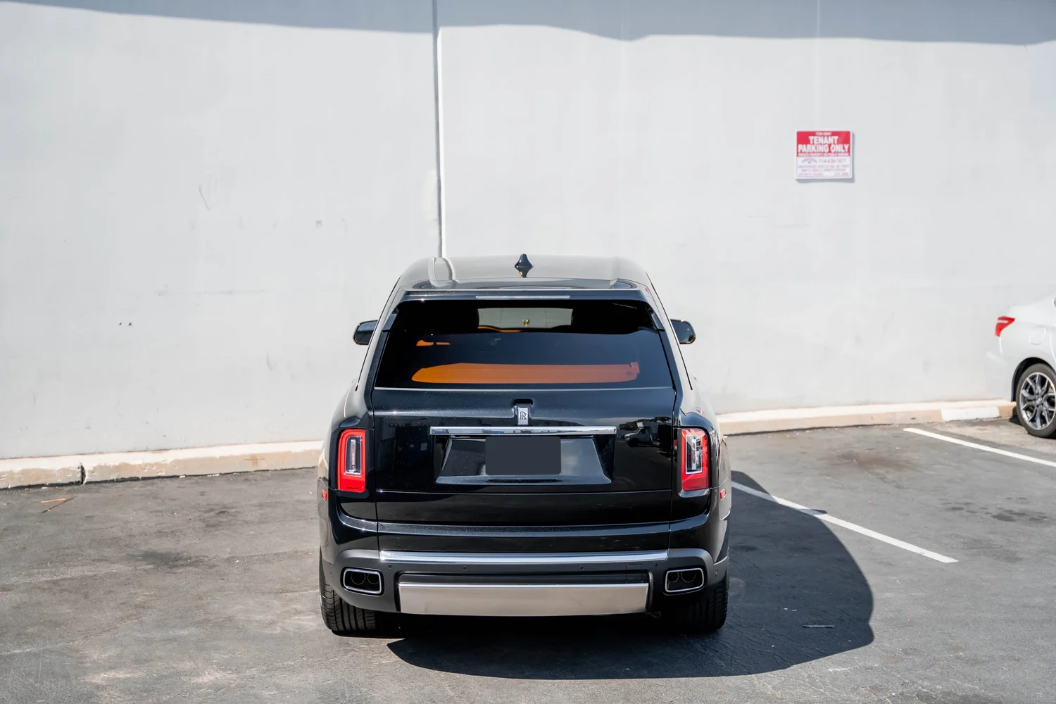 Black Rolls-Royce Cullinan with Chrome Exterior Trim after Paint Protection Film (PPF), Window Tint and Ceramic Coating, low-angle rear view