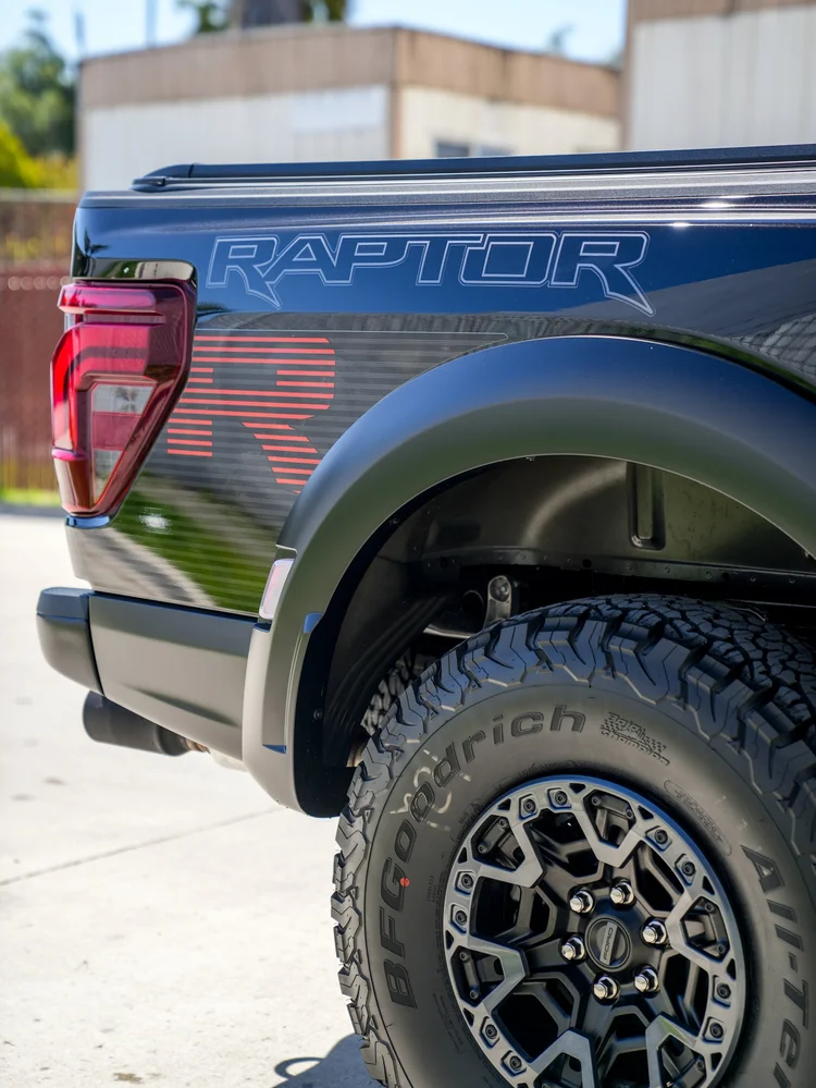 Raptor bedside lettering and red graphic above the rear wheel arch.