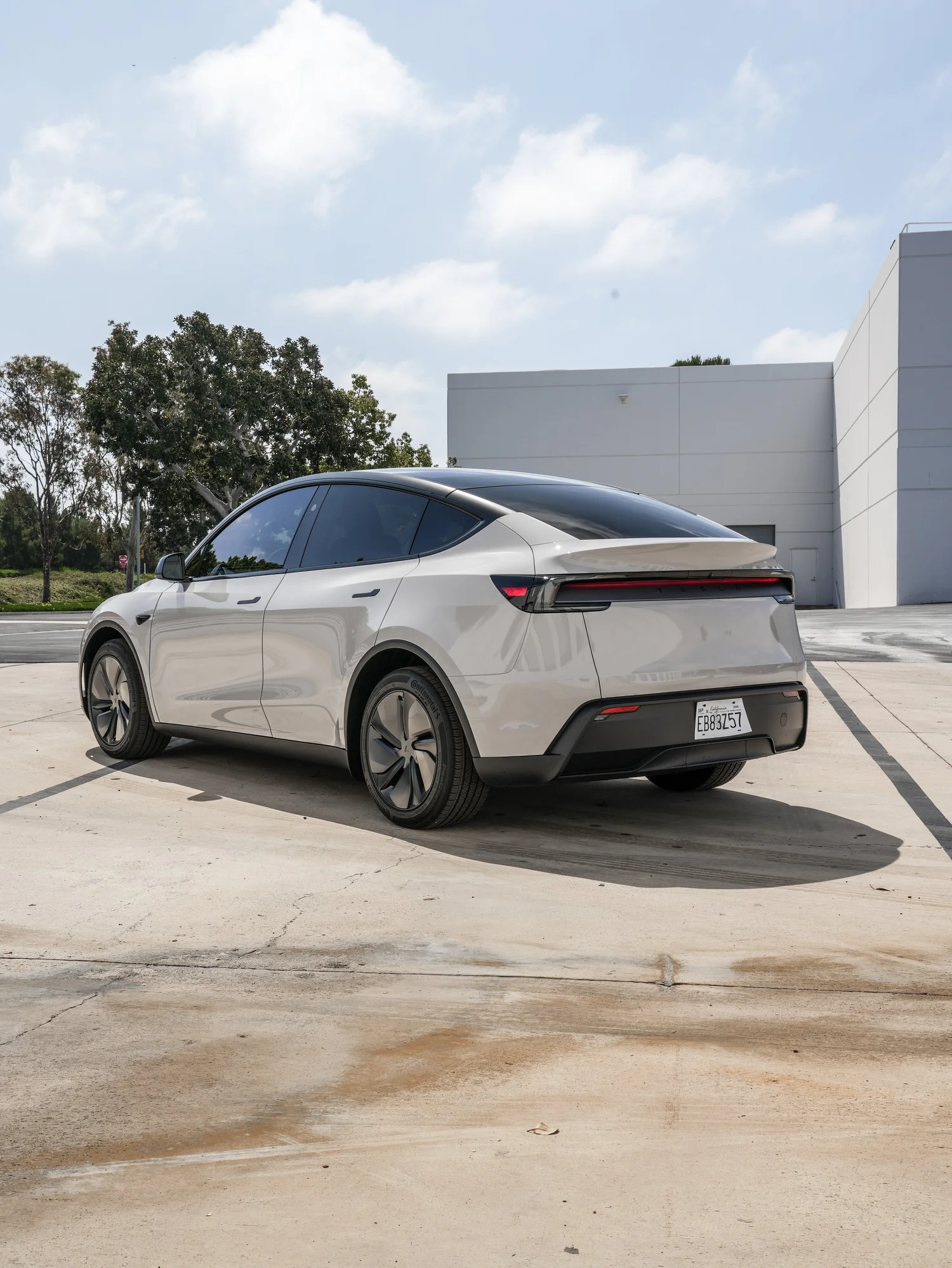 Tesla Model Y Chalk Grey Wrap after Vinyl Wrap, rear-left three-quarter view