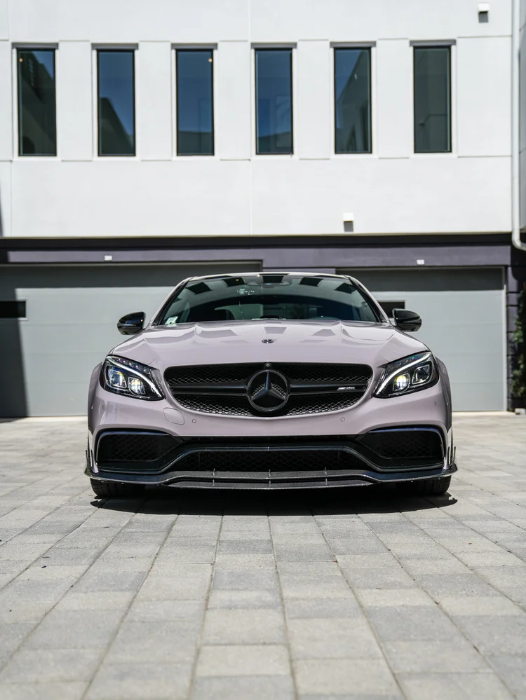 Straight front view of the light-grey C 63 S showing both headlamps, mirrors, grille and lower splitter