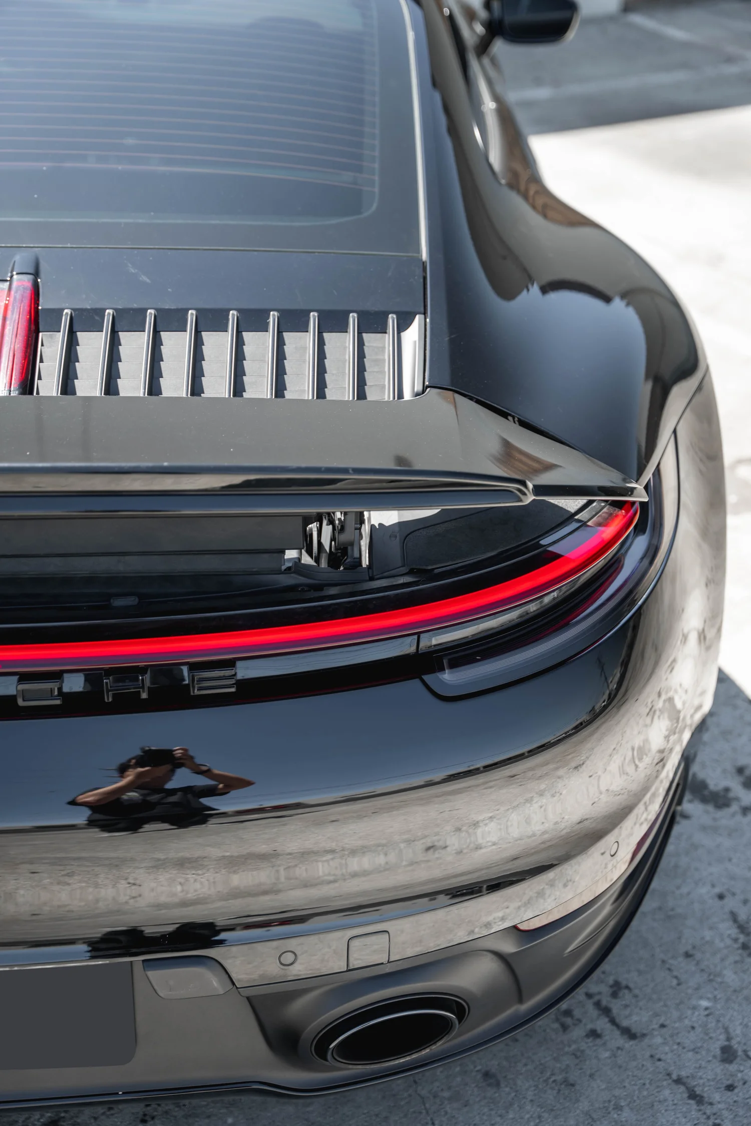 Porsche 911 Carrera S (992.1) after Paint Protection Film (PPF) and Ceramic Coating, rear bumper and taillight detail