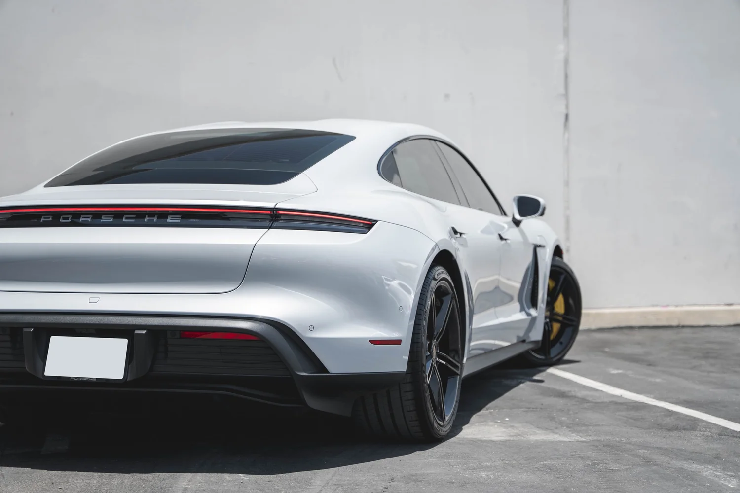 Porsche Taycan after Paint Protection Film (PPF), Window Tint and Ceramic Coating, rear-quarter and wheel view