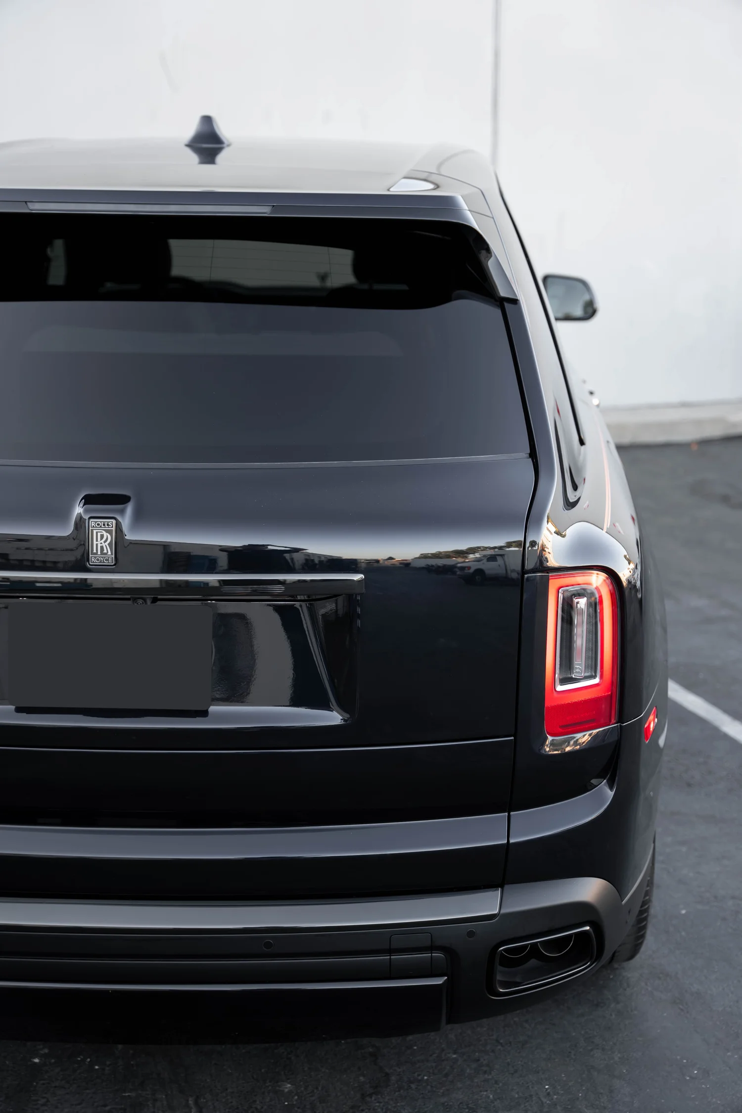 Black Rolls-Royce Cullinan Black Badge after Paint Protection Film (PPF), Window Tint and Ceramic Coating, rear bumper and taillight detail
