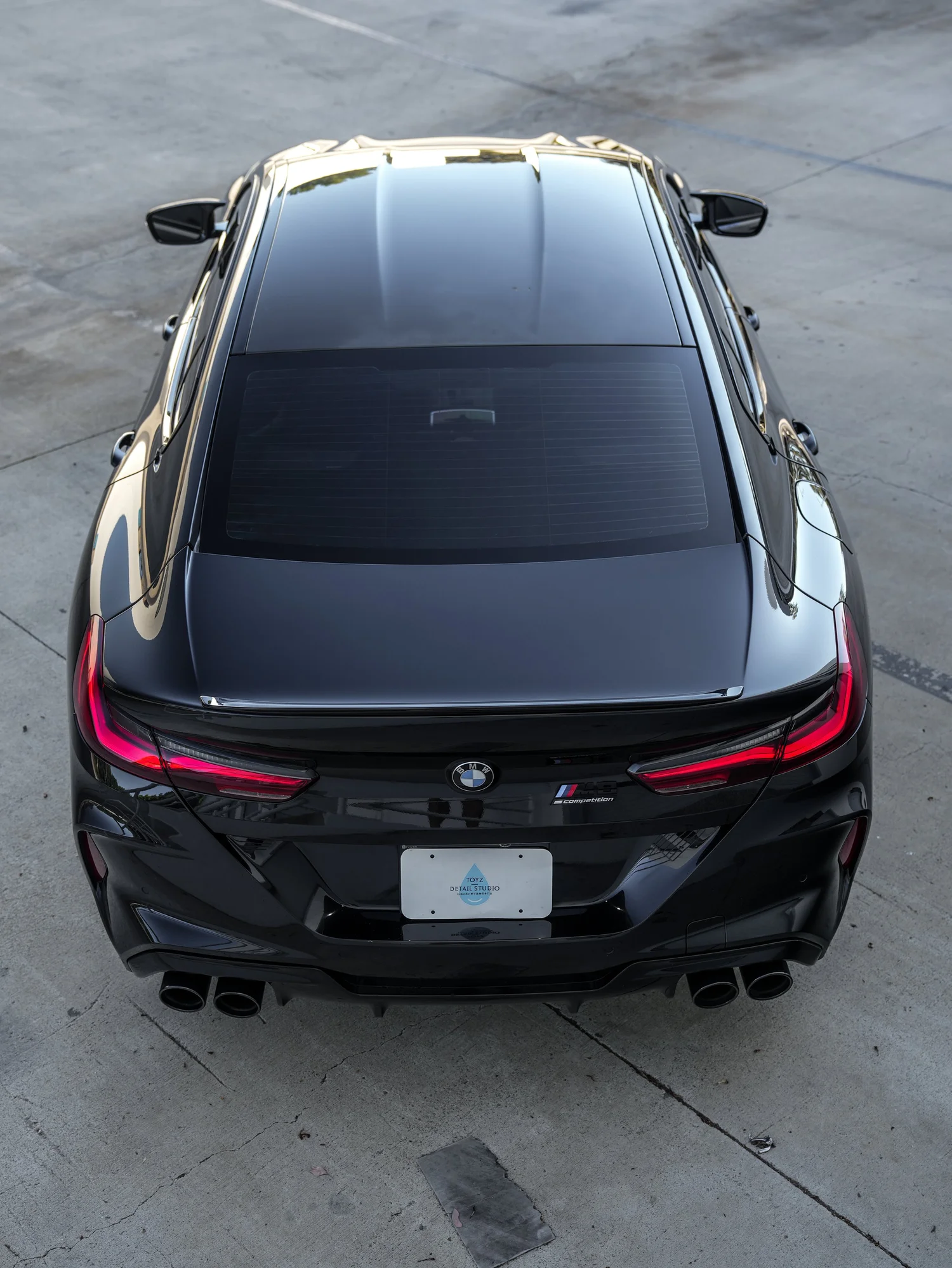 BMW M8 Paint Correction after Ceramic Coating, low-angle rear view