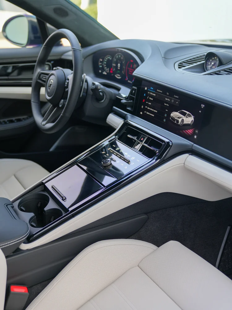 Panamera steering wheel, dashboard and center console beside light-colored seats