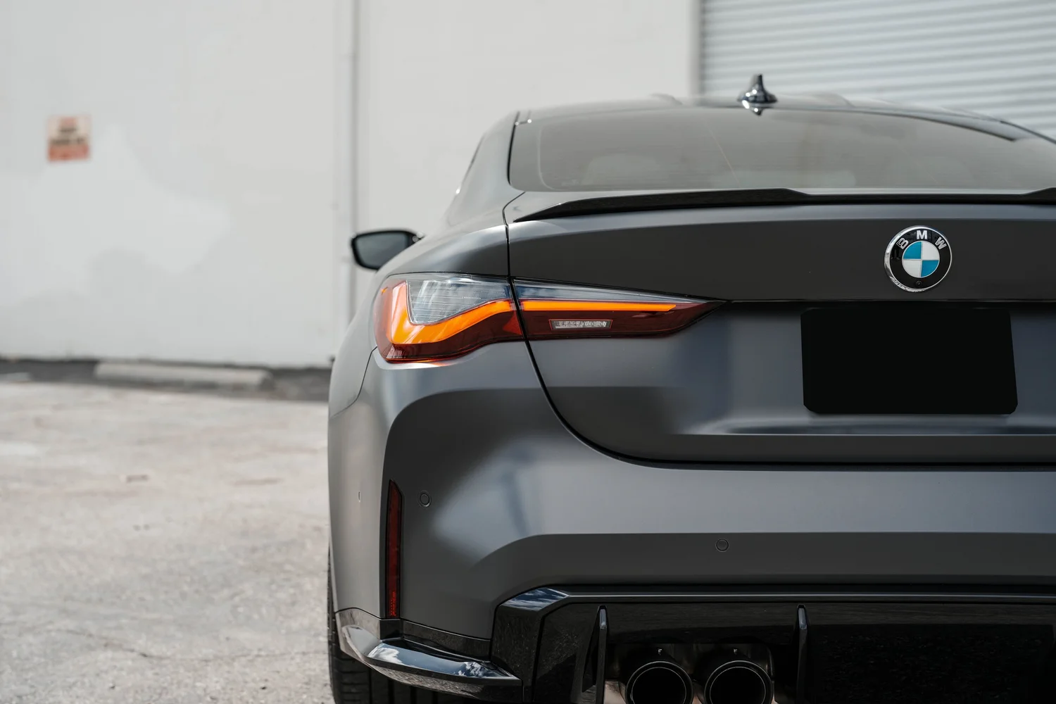 Black BMW M4 after Matte PPF, Window Tint and Ceramic Coating, rear diffuser and exhaust detail